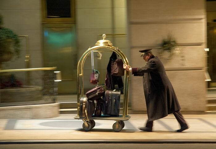 a man pushing a cart with luggage