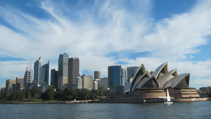 a city skyline with a boat in the water