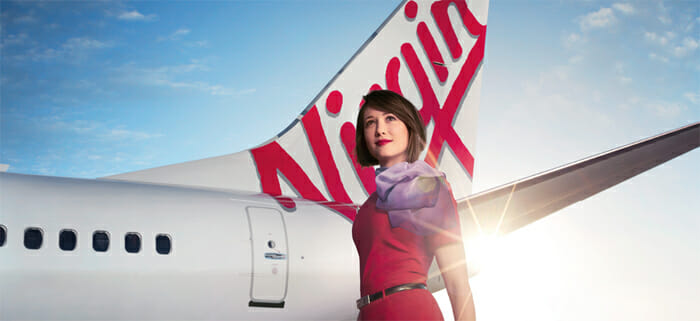 a woman standing next to a plane