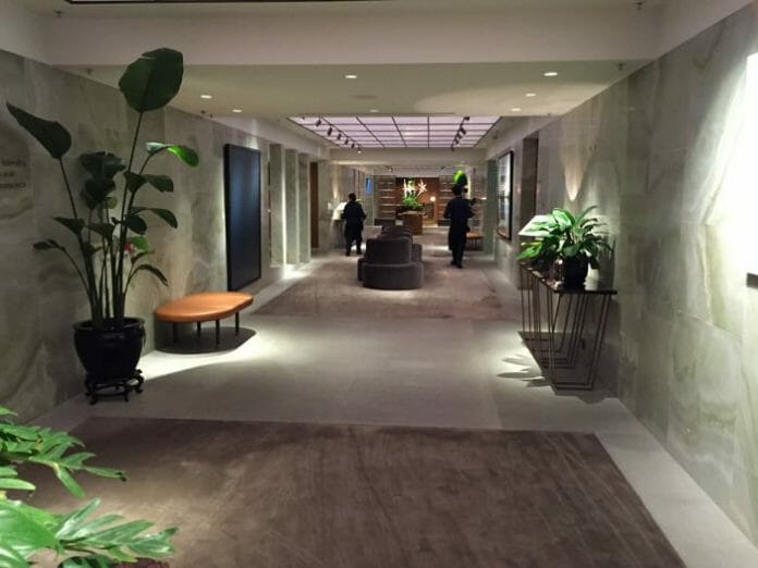 a hallway with plants and a large round table