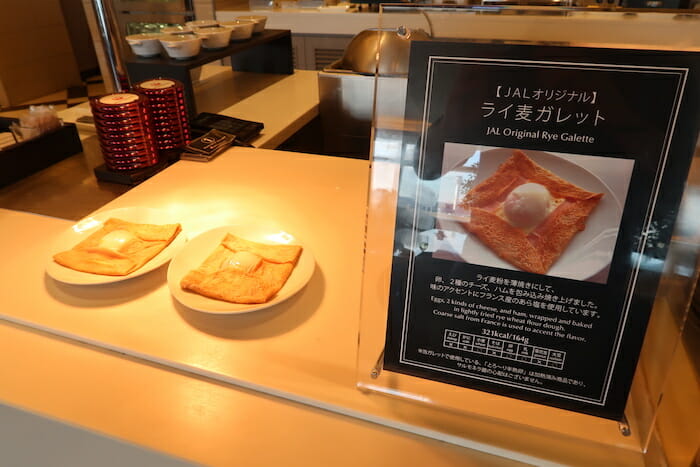 a sign on a counter with food on it