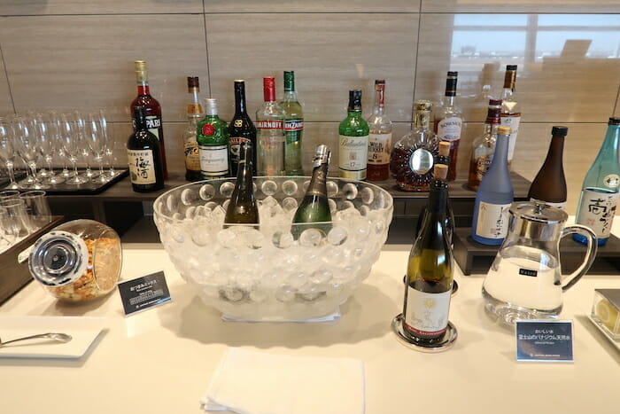 a group of bottles of alcohol in a bowl on a table