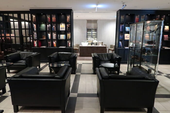 a room with black furniture and bookshelves