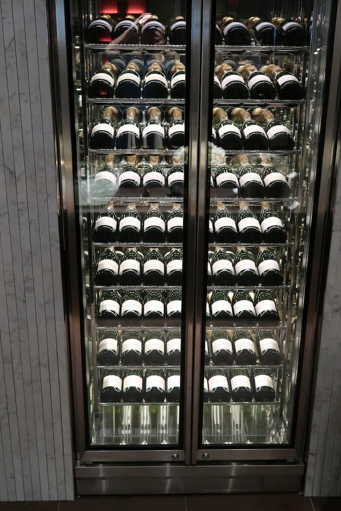 a glass case with bottles of wine