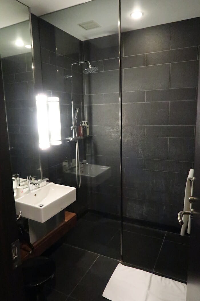 a bathroom with a shower and sink