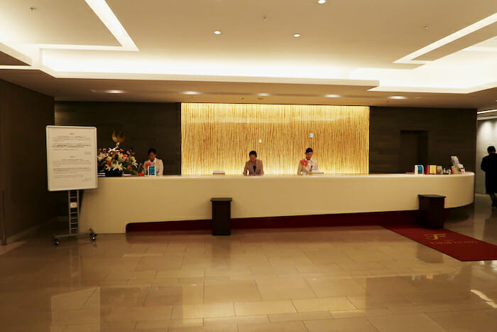 a group of people standing at a reception desk