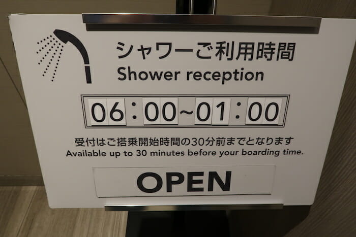 a sign with a shower head and a shower head