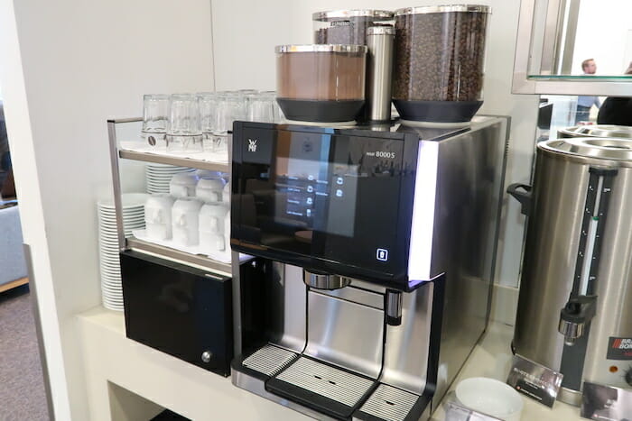 a coffee machine with a container of coffee beans