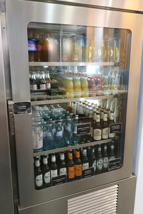 a refrigerator with bottles of drinks