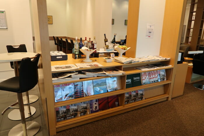 a shelf with magazines and bottles on it