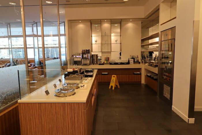 a restaurant with a counter and a yellow sign