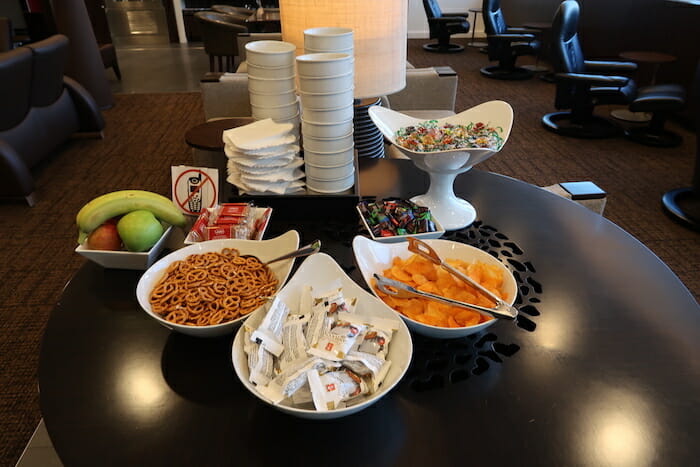 a table with bowls of snacks and snacks