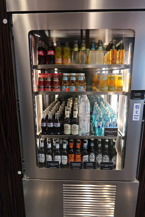 a refrigerator with bottles of beverages