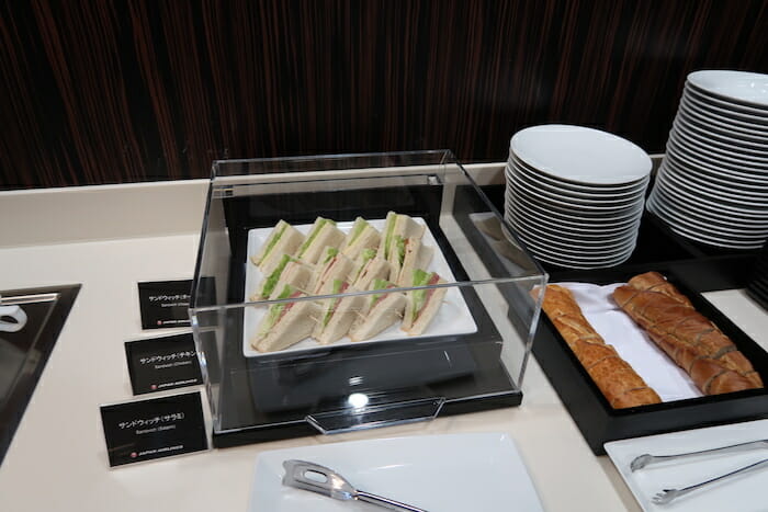 a tray of sandwiches and bread on a table