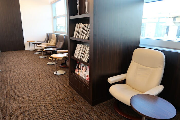 a room with chairs and a bookcase