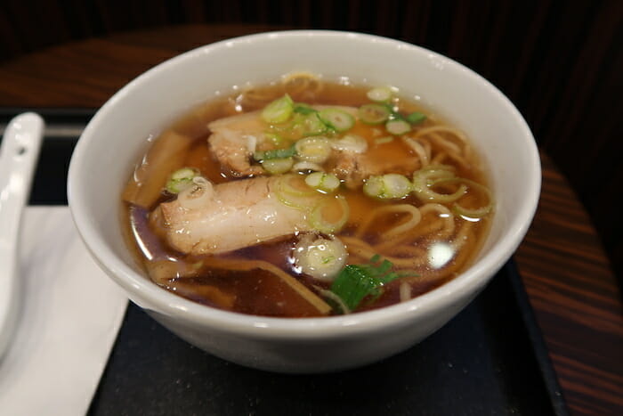 a bowl of soup with noodles and meat