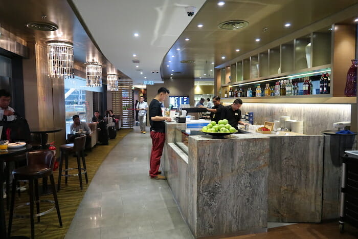 a group of people standing at a counter in a restaurant