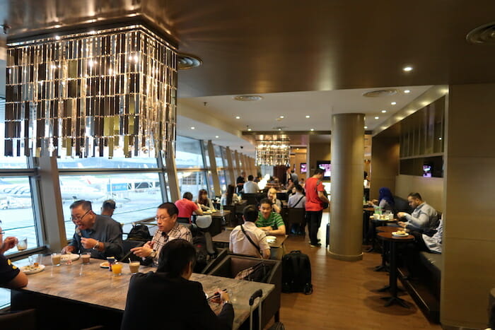 a group of people sitting at tables in a restaurant