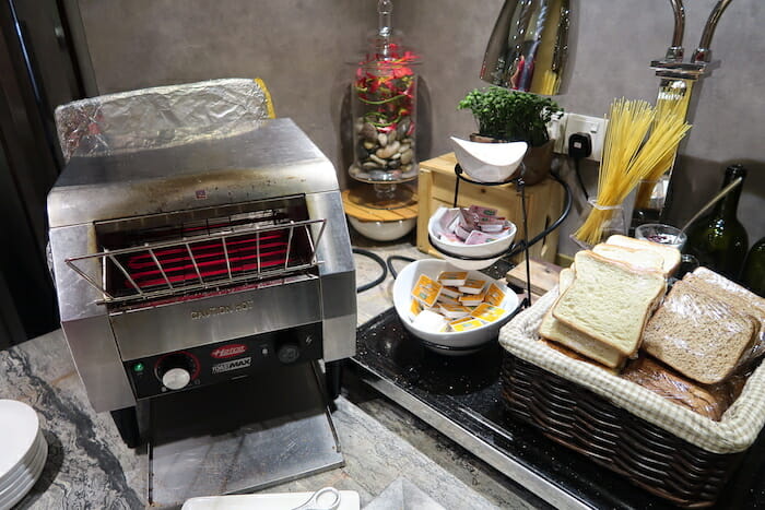 a toaster machine and a basket of bread