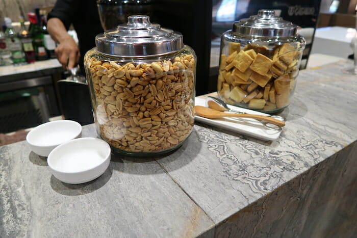 a couple of glass jars with nuts and crackers