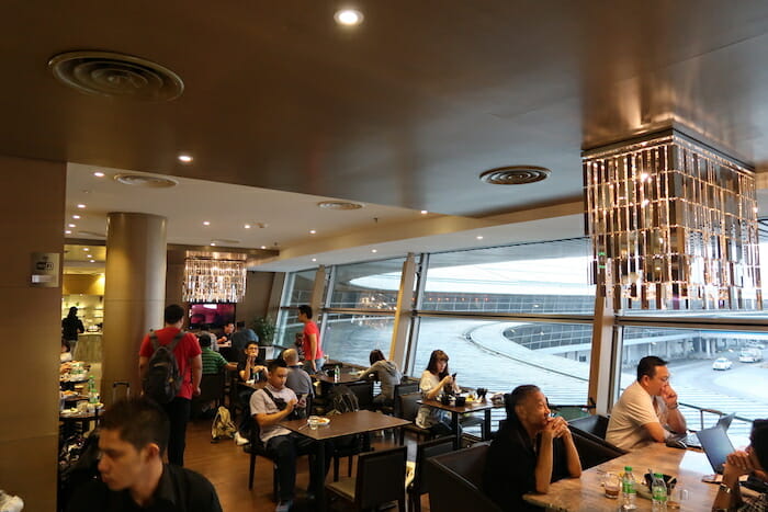 a group of people sitting at tables in a restaurant