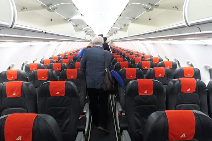 a man walking in an airplane