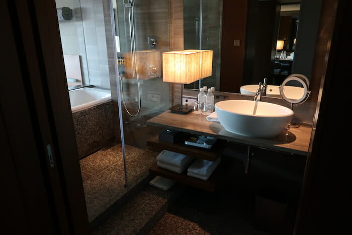 a bathroom with a sink and a lamp