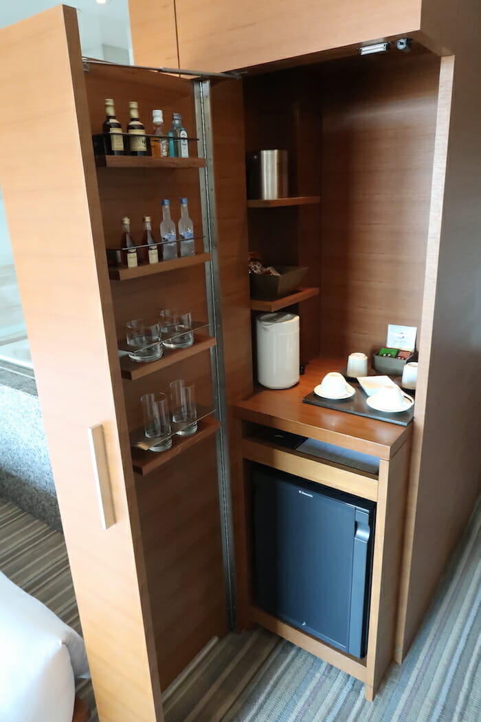 a small room with a small cabinet and a small refrigerator