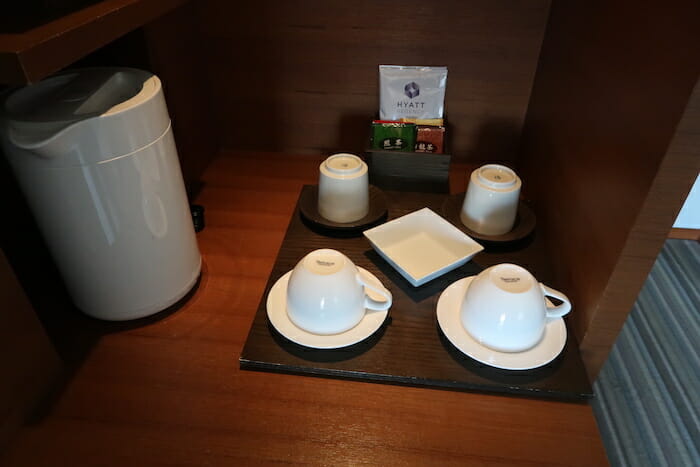 a tray with cups and saucers on a table