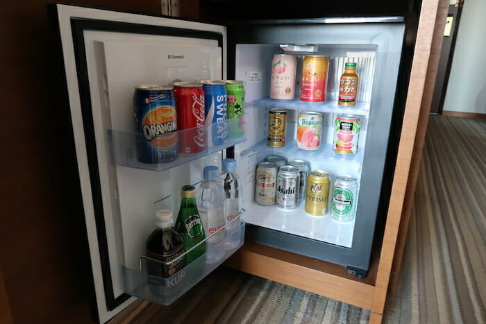 a refrigerator with drinks and cans