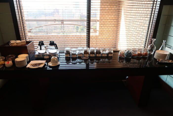 a table with jars of spices and coffee