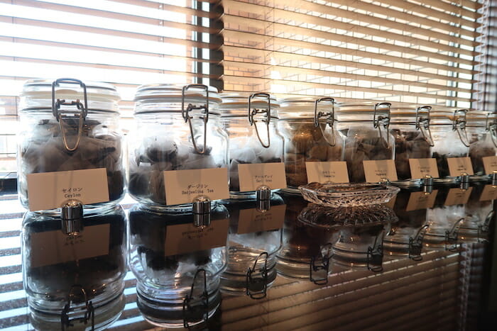 a row of glass jars with labels on them