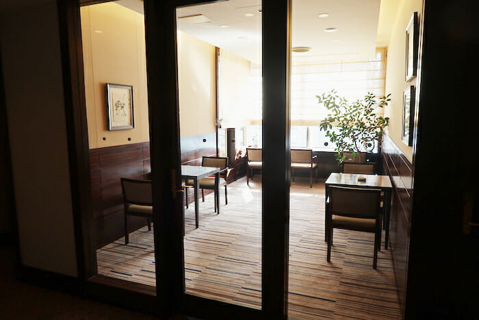 a glass door with a table and chairs