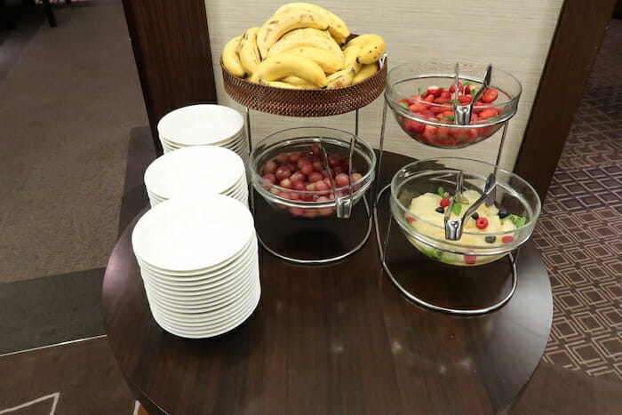 a table with plates and bowls of fruit