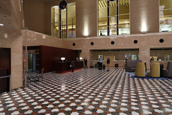 a large tiled floor with people standing in front of it