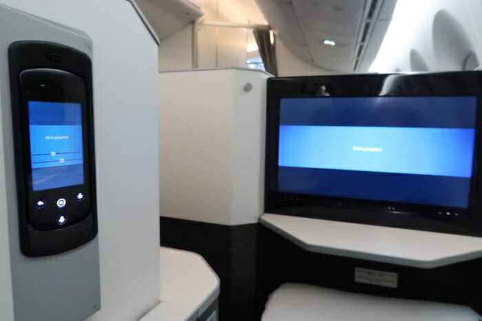 a tv and a screen on a plane