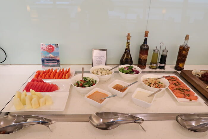 a buffet table with food and sauces