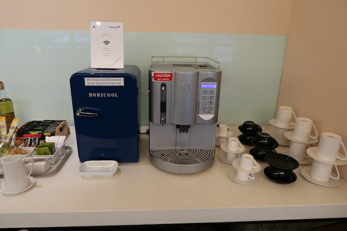 a coffee machine and a blue refrigerator on a counter