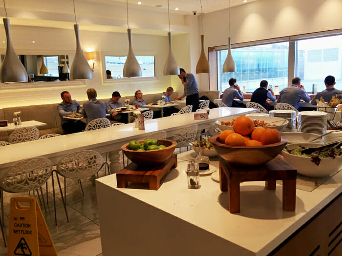 a group of people sitting at tables in a restaurant