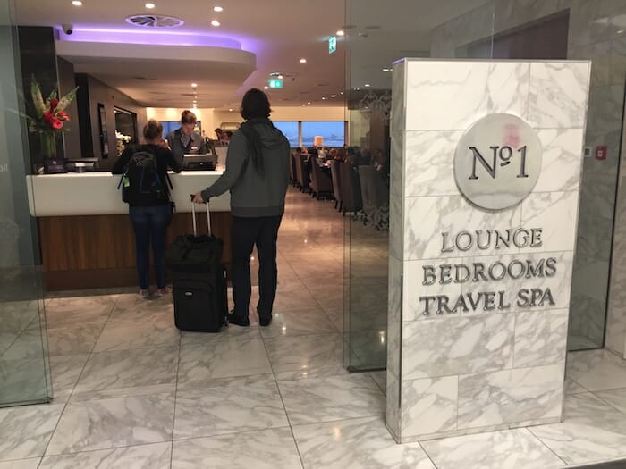 a person with luggage in front of a hotel reception