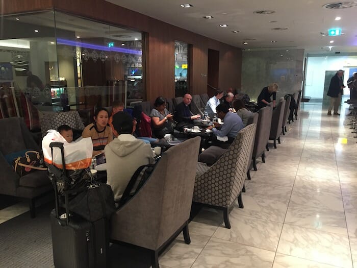 a group of people sitting at tables in a room with chairs