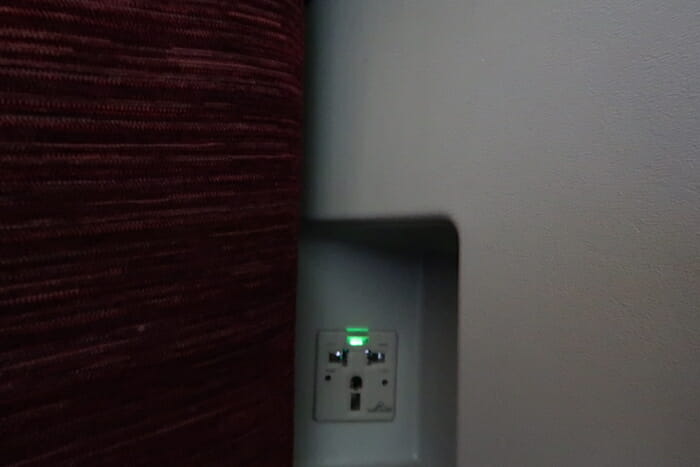 a wall outlet with green light