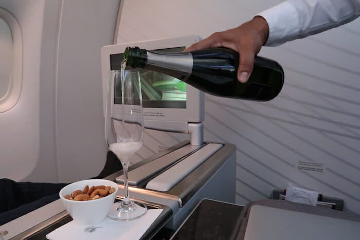 a person pouring wine into a glass