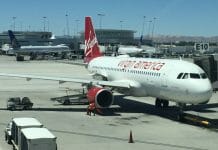 a large white airplane with red text on it