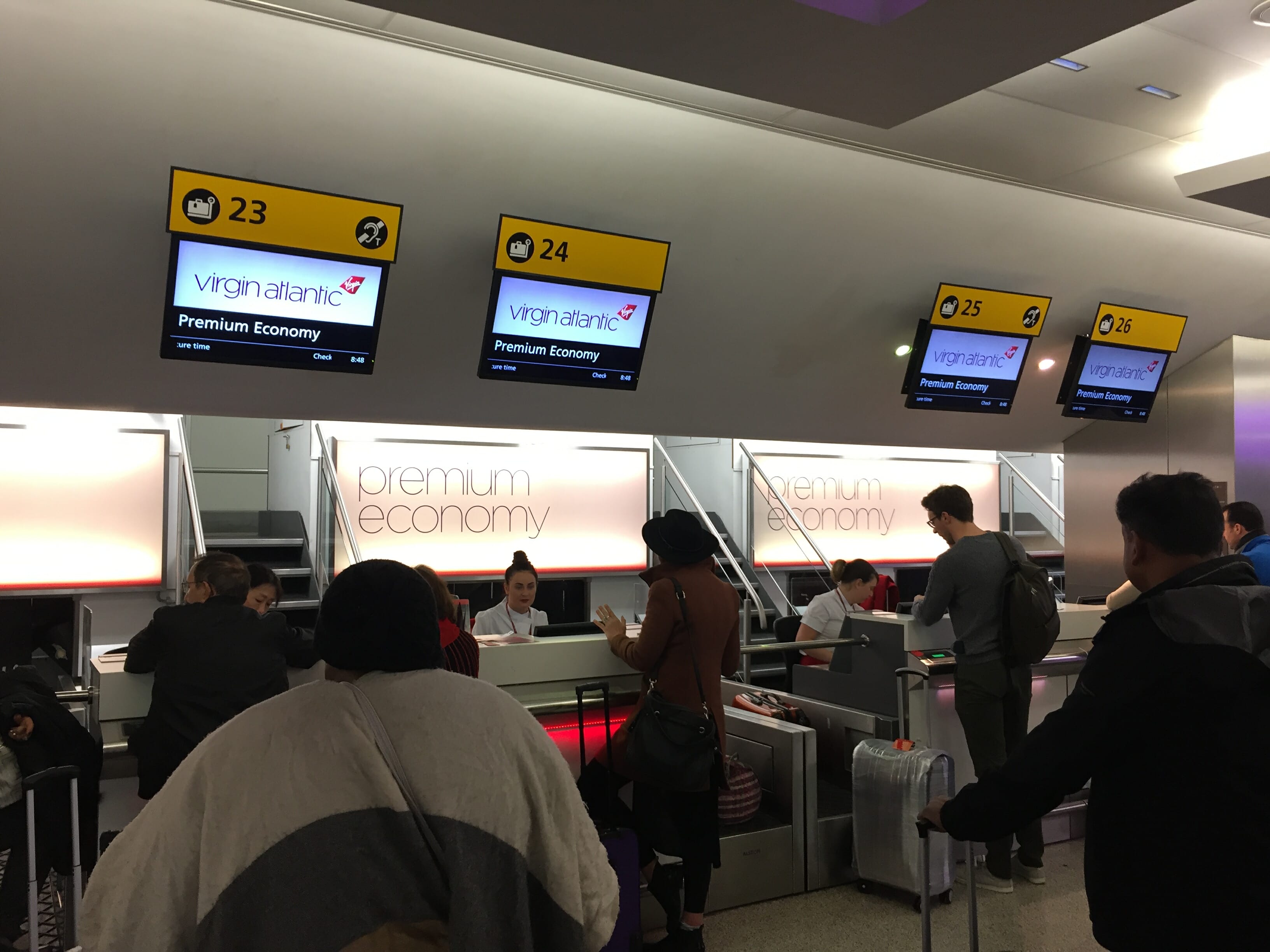 people standing in a line at an airport