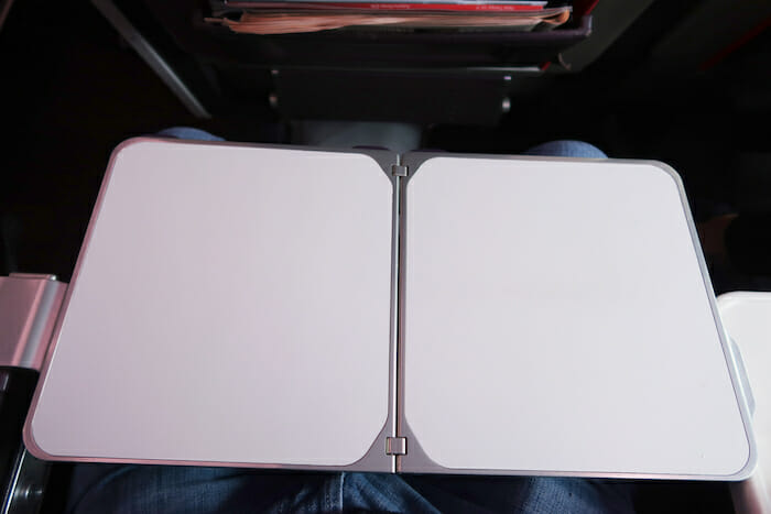 a white rectangular object on a person's lap