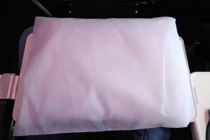 a white pillow on a black surface