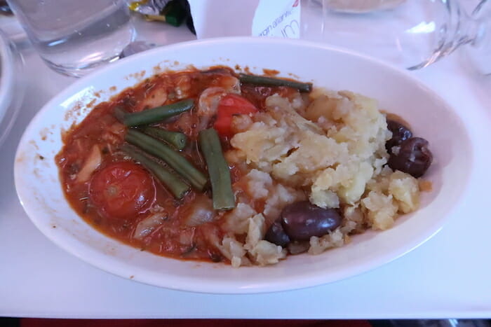 a bowl of soup with vegetables and potatoes