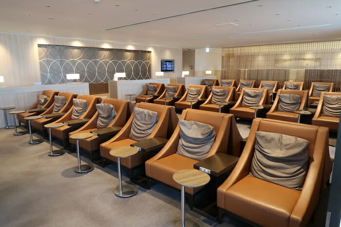 a room with brown chairs and tables