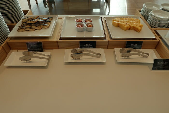 a table with plates of food and utensils